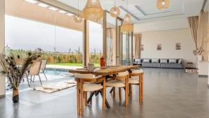 a dining room with a table and chairs at Life resort Marrakech 
