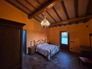 a bedroom with a bed and a chandelier at Villa Benedetti in Galleno +34 photos