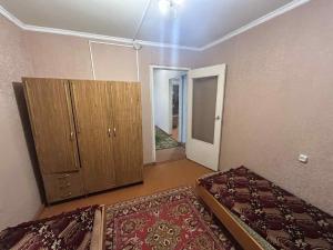 an empty room with two beds and a cabinet at Սեփական տուն in Vanadzor