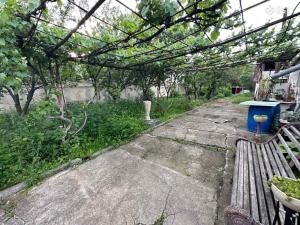 a walkway with a bench and a trash can at Սեփական տուն in Vanadzor +2 photos