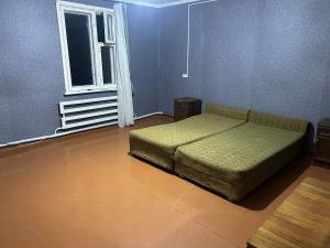a bedroom with a bed in a room with a window at Սեփական տուն in Vanadzor