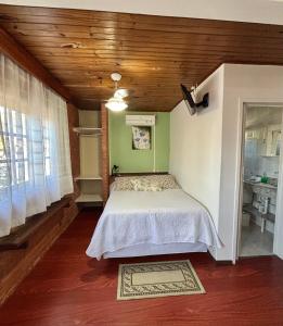a bedroom with a bed and a wooden ceiling at Morada das Pedras in Florianópolis +47 photos