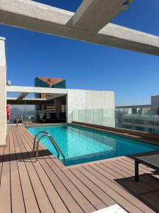 a swimming pool on the deck of a building at Matías Plaza in Santiago