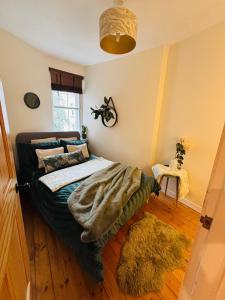 a bedroom with a bed with a blanket on it at Diagon Alley two bed apartment Victoria street grassmarket in Edinburgh
