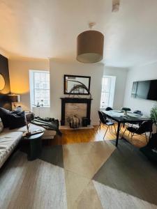 a living room with a couch and a table at Diagon Alley two bed apartment Victoria street grassmarket in Edinburgh