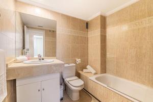 a bathroom with a sink and a toilet and a tub at Apartamento Costa Nagüeles 2hab. in Marbella +7 photos