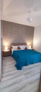 a bedroom with a blue bed in a room at Dimora Mariflor in Anagni