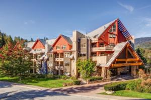 an apartment building with red roof at Lake Placid Lodge 126 in Whistler