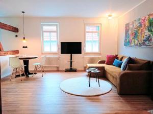 a living room with a couch and a table at Studio-Apartment in Eisenberg, Thüringen in Eisenberg