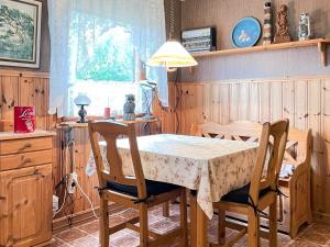 a dining room with a table and two chairs at 4 person holiday home in SMEDSTORP in Smedstorp +19 photos