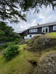 a house sitting on top of a grassy hill at 3 BR home for 9 guests in a quiet neighborhood in Tórshavn