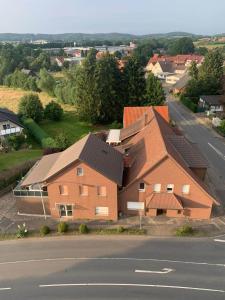 a large brick house on the side of a road at Ecke's Apartment in Hüllhorst