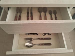 a drawer filled with utensils in a drawerlictsangering at Torre Esmeralda 740 in Buenos Aires