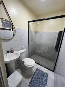a bathroom with a shower and a toilet and a sink at Quarto Casal em Belém in Belém
