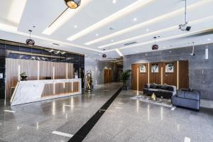 a lobby with a couch and a table at Cozy Studio at walking distance from Burj Khalifa and Downtown Dubai in Dubai