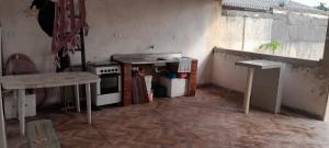a small kitchen with a stove and a counter top at Casa de praia Coroados in Guaratuba