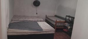 two twin beds in a room with a staircase at Casa de praia Coroados in Guaratuba