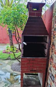 a brick oven sitting on the side of a building at Enseadabechouse in Cabo de Santo Agostinho