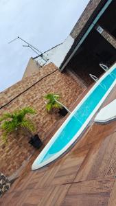 a blue and white surfboard sitting on top of a building at Enseadabechouse in Cabo de Santo Agostinho