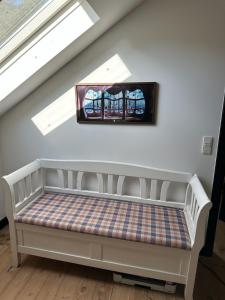 a bench in a room with a window at Charming apartment by forest & beach on Tåsinge in Svendborg
