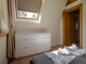 a bedroom with a bed with a dresser and a window at Osada Gubałówka na Polanie Pająkówka View Jacuzzi & Sauna in Kościelisko +132 photos
