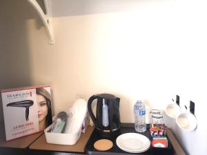 a counter top with a coffee maker and other items on it at Private Room 2- Affordable Luxury in Craigieburn