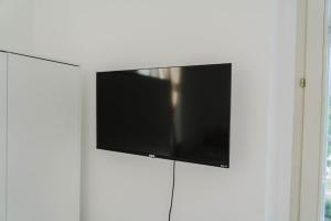 a flat screen tv hanging on a white wall at Apartment Reiger in Arnoldstein