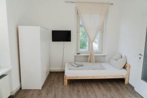 a white room with a bed and a window at Apartment Reiger in Arnoldstein