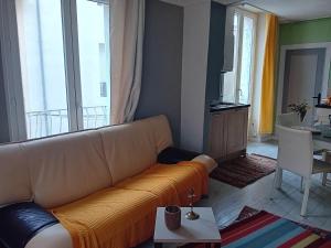 a living room with a couch and a table at Appartement centre de Lodève in Lodève