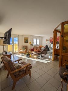 a living room with a couch and a tv at Apartment Above the Rooftops - Mountain Panorama in Naters