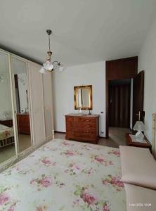 a bedroom with a bed and a dresser and a mirror at Casa Nana' in Thiene