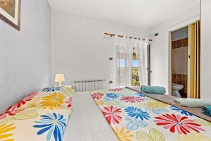a bedroom with a bed with a floral bedspread at Apartments Fjord in Brajkovići +80 photos