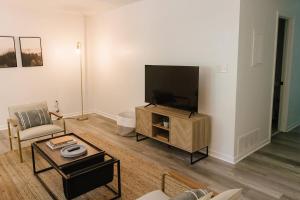 a living room with a flat screen tv on a stand at "Morning View 4” Cozy Modern Stay - College/Hiking in Berea
