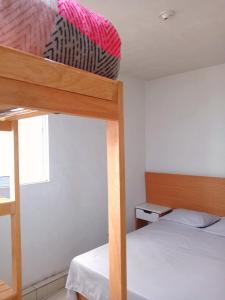 a bedroom with two bunk beds and a window at Lindo departamento in Toluca +6 photos