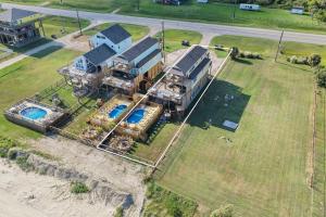 an aerial view of a large house with a pool at Seadreamz! Beachfront Heated Salt Pool! Sleep24! in Caplen