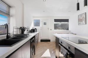 a kitchen with a sink and a counter top at Spenny Homestay - Monthly & Weekly Stays in Byers Green