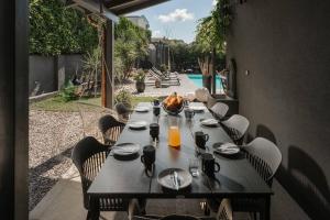 a table set for a meal on a patio at Villa Giardino di Eva in Kukci