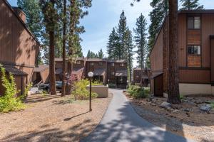 a walkway through a park with trees and buildings at Club Tahoe Resort in Incline Village