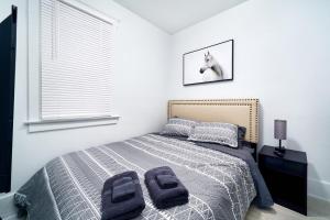 a bedroom with a bed with two towels on it at Newly renovated 3 bedroom unit in Windsor