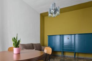 a dining room with a table and a blue cabinet at Oltre Natura in Canneto Pavese