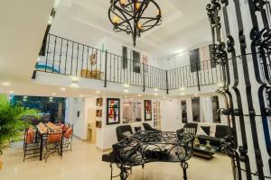 a large living room with a table and chairs at Walled City 9BR Luxury Villa - Jacuzzi & Pool Table in Cartagena de Indias