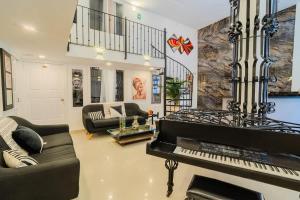 a living room with a piano and a couch at Walled City 9BR Luxury Villa - Jacuzzi & Pool Table in Cartagena de Indias +49 photos