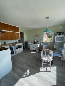 a kitchen and dining room with a table and chairs at Skokkelvika gård in Vestvågøya +4 photos