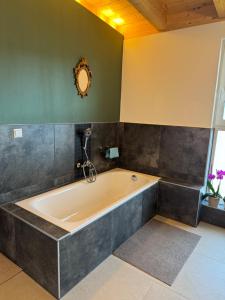La salle de bains est pourvue d'une grande baignoire et d'un miroir. dans l'établissement Penthouse 17 Vils, à Vils 9 autres photos
