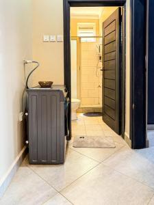 a door to a bathroom with a suitcase on the floor at Oasis Villas- Naalya in Kampala