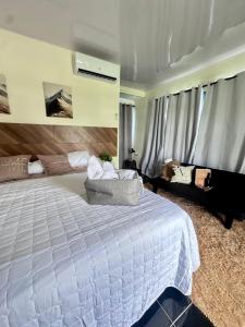 a bedroom with a large white bed and a couch at Villa Seven in Guerra +13 photos
