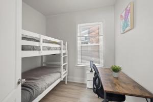 a bedroom with a desk and bunk beds and a table at New Build Sunny 2 Bedroom Unit in Windsor