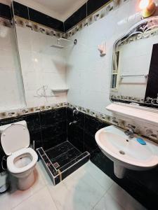 a bathroom with a toilet and a sink at Porto Sokhna pyramids Family Only in Ain Sokhna