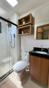 a bathroom with a toilet and a sink and a shower at 306-3 · Studio Completo in Anápolis
