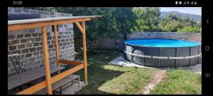 a large swimming pool in a yard next to a building at Uriner-Rest in Yerevan +6 photos